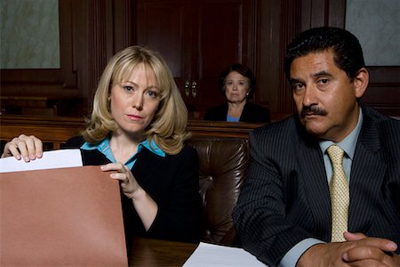 defense lawyer - Man and woman sitting in court, portrait Stock Photo - Premium Royalty-Free, Code: 694-03330826