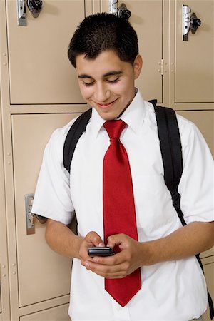 student phone school - High School Boy Text Messaging by School Lockers Stock Photo - Premium Royalty-Free, Code: 694-03331083