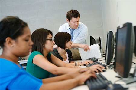 students teacher computers - Teacher Helping Student in Computer Lab Stock Photo - Premium Royalty-Free, Code: 694-03331131