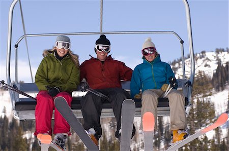 ski goggles mature not senior - Three Skiers on Chair Lift Stock Photo - Premium Royalty-Free, Code: 694-03331333