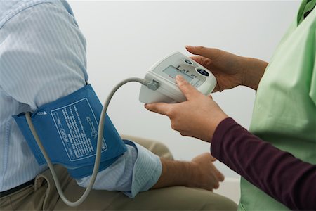Doctor checking patients blood pressure,close-up Stock Photo - Premium Royalty-Free, Code: 694-03331724