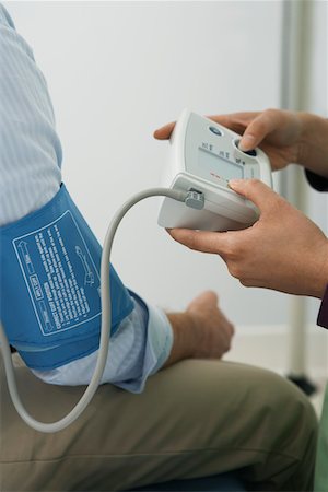 Doctor checking patients blood pressure,close-up Stock Photo - Premium Royalty-Free, Code: 694-03331725