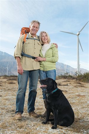 Senior couple with dog near wind farm Stock Photo - Premium Royalty-Free, Code: 694-03332645