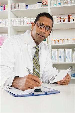 simsearch:694-03332775,k - Male pharmactist working in pharmacy Stock Photo - Premium Royalty-Free, Code: 694-03332776