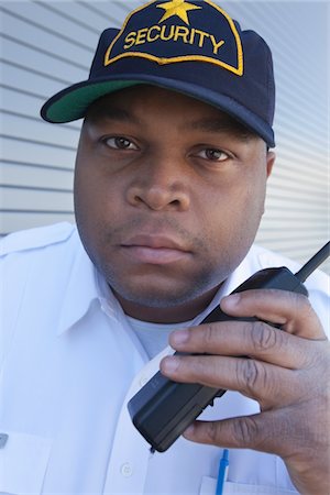 fat men in uniform - Security guard with walky talk Stock Photo - Premium Royalty-Free, Code: 694-03474746