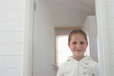 Young girl standing inside, head and shoulders, portrait Stock Photo - Premium Royalty-Free, Code: 694-03694013