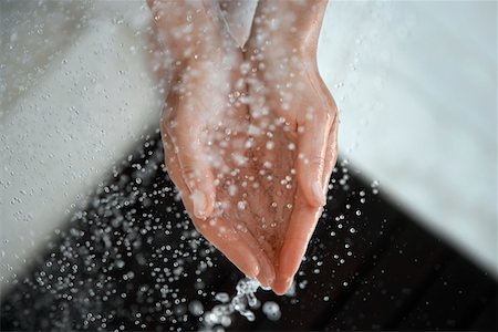 simsearch:649-08144531,k - Woman catching water in cupped hands, close up of hands, view from above Stock Photo - Premium Royalty-Free, Code: 694-03694095