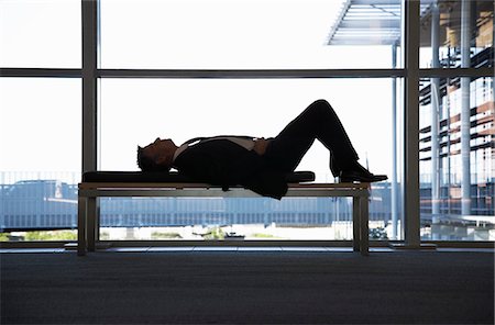 sleeping by the window - Businessman sleeping on bench in office building Stock Photo - Premium Royalty-Free, Code: 694-03694135