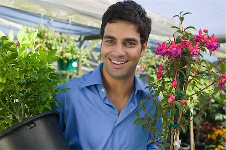 simsearch:694-03692195,k - Man Carrying Plants in plant nursery, portrait Stock Photo - Premium Royalty-Free, Code: 694-03692199