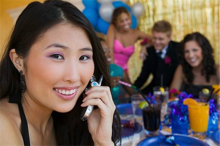 simsearch:694-03318741,k - Well-dressed teenager girl using cell phone at school dance Fotografie stock - Premium Royalty-Free, Codice: 694-03692584