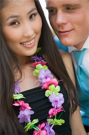simsearch:694-03318741,k - Well-dressed teenage couple wearing leis outside school dance Fotografie stock - Premium Royalty-Free, Codice: 694-03692598