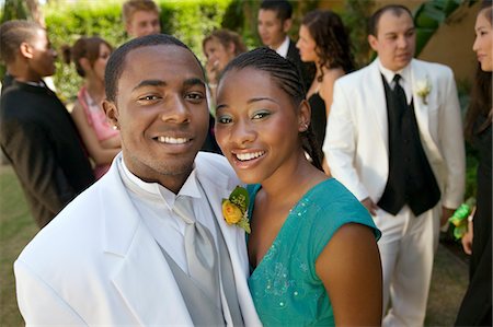 Well-dressed teenage couple standing outside school dance Stock Photo - Premium Royalty-Free, Code: 694-03692591