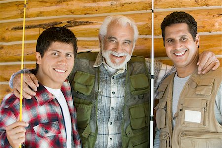 portrait fisherman older - Middle-aged man with two sons holding fishing rods, smiling, (portrait) Stock Photo - Premium Royalty-Free, Code: 694-03692705