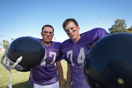 face painting for football - Two Football Players Holding Helmets on field, portrait Stock Photo - Premium Royalty-Free, Code: 694-03692855