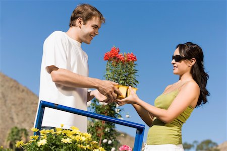 people shopping garden center model release property release - Young couple choosing potted flowers in garden centre, (low angle view) Stock Photo - Premium Royalty-Free, Code: 694-03693013