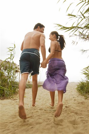 Couple Holding Hands, Walking on Beach, back view Stock Photo - Premium Royalty-Free, Code: 694-03693077