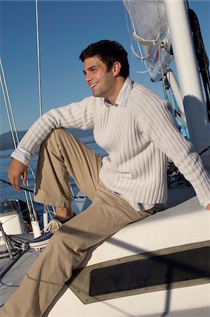 Young man relaxing on sailboat Stock Photo - Premium Royalty-Free, Code: 694-03693122