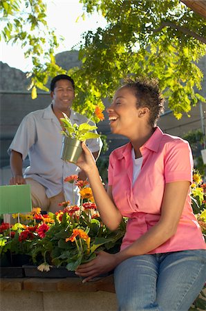 people shopping garden center model release property release - Woman smelling flowers at plant nursery Stock Photo - Premium Royalty-Free, Code: 694-03693267