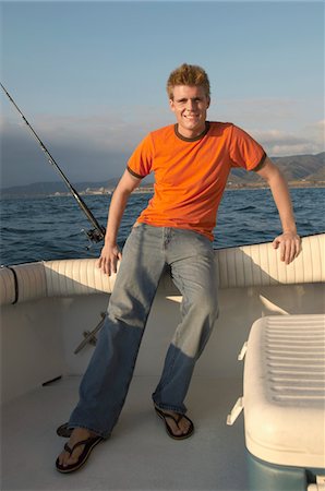 fishing boats recreational - Fisherman on boat, (portrait) Stock Photo - Premium Royalty-Free, Code: 694-03693317