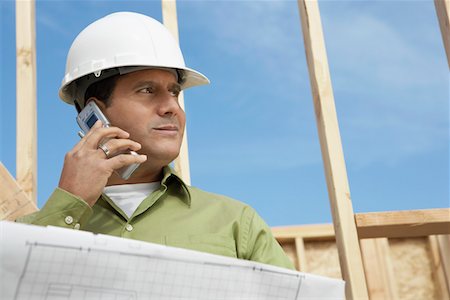 simsearch:693-06016692,k - Construction Worker wearing hard hat, Using Cell Phone on construction site Stock Photo - Premium Royalty-Free, Code: 694-03693534