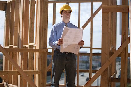 Site manager with building plans Stock Photo - Premium Royalty-Free, Code: 694-03783197