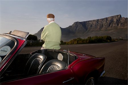 people old car - Senior man admires view leaning on vintage racing car on Signal Hill, Cape Town, South Africa Stock Photo - Premium Royalty-Free, Code: 694-03783268