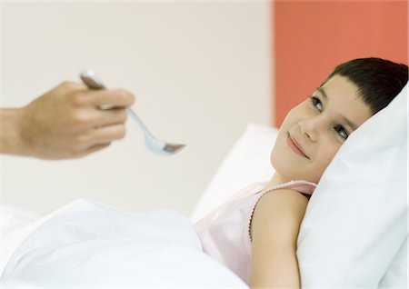 simsearch:695-05764394,k - Child in bed, being fed with spoon Stock Photo - Premium Royalty-Free, Code: 695-05764369