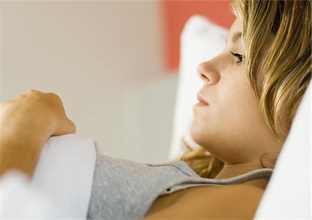 female teenage ill - Young woman lying in bed Stock Photo - Premium Royalty-Free, Code: 695-05764384