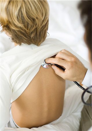 doctor listening boy - Doctor holding stethoscope to boy's back Stock Photo - Premium Royalty-Free, Code: 695-05764386