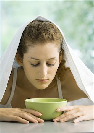 Woman with face over bowl and towel over head Stock Photo - Premium Royalty-Free, Code: 695-05764380