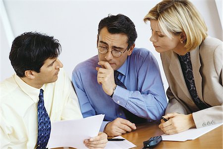 Business colleagues studying document Stock Photo - Premium Royalty-Free, Code: 695-05764449
