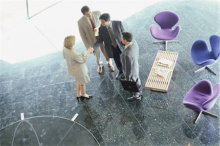 executive welcome - Businesswoman greeting businessmen in lobby, high angle view Stock Photo - Premium Royalty-Free, Code: 695-05764492
