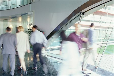 Business executives walking in lobby, blurred motion Stock Photo - Premium Royalty-Free, Code: 695-05764508