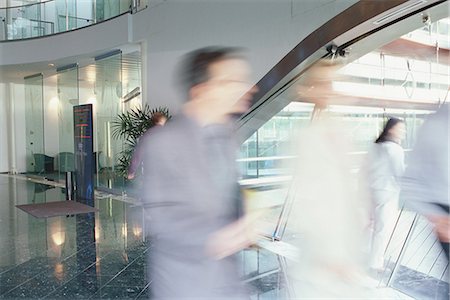 Business executives walking in lobby, blurred motion Stock Photo - Premium Royalty-Free, Code: 695-05764510