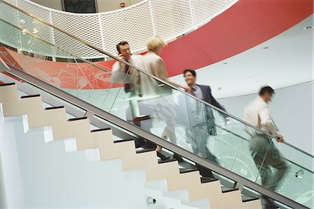 simsearch:695-03381633,k - Business executives going up and down staircase Stock Photo - Premium Royalty-Free, Code: 695-05764521
