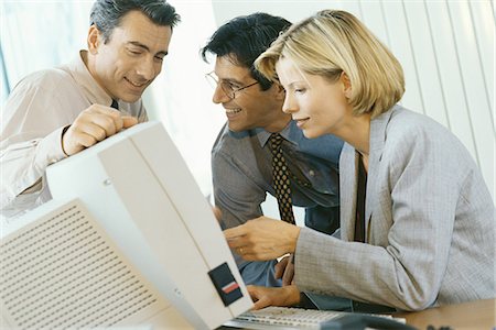 Business associates working at desktop computer Stock Photo - Premium Royalty-Free, Code: 695-05764554
