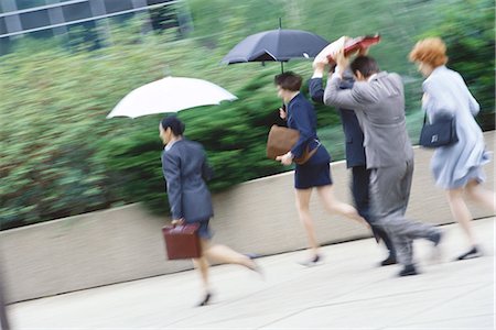 simsearch:6113-06899615,k - Group of business executives hurrying through rain Stock Photo - Premium Royalty-Free, Code: 695-05764579