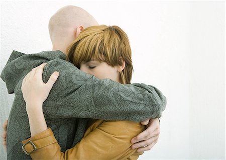 silhouette couple embracing - Young adult couple hugging, woman closing eyes Stock Photo - Premium Royalty-Free, Code: 695-05765098