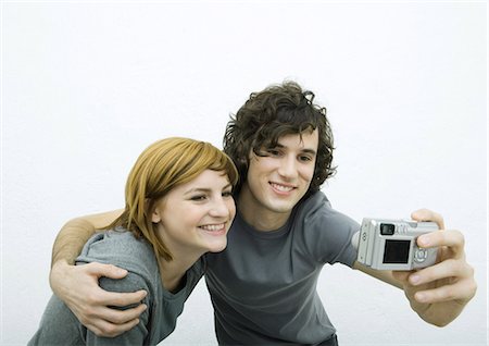 Young couple taking photo together Stock Photo - Premium Royalty-Free, Code: 695-05765091
