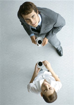 Male and female associates having coffee, full length, high angle view Stock Photo - Premium Royalty-Free, Code: 695-05765217