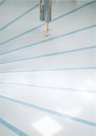 fashion women flip flops - Woman walking across rayed floor, low section Stock Photo - Premium Royalty-Free, Code: 695-05765221