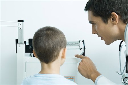 Doctor weighing boy during check-up Stock Photo - Premium Royalty-Free, Code: 695-05765420