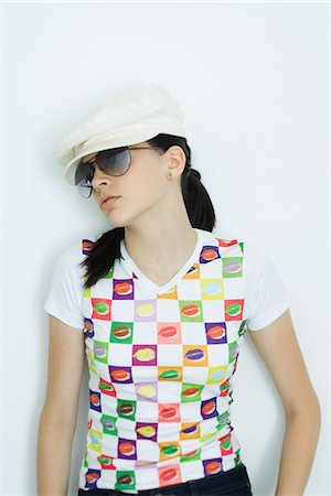 Teen girl wearing cap and sunglasses, portrait Stock Photo - Premium Royalty-Free, Code: 695-05765889