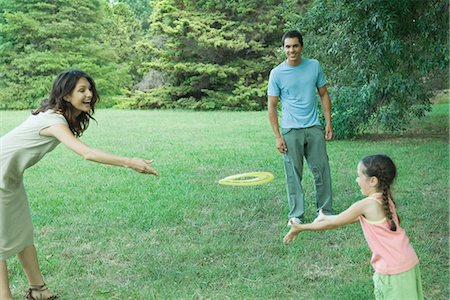 Family playing with plastic disc Stock Photo - Premium Royalty-Free, Code: 695-05765934