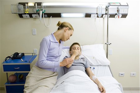 sick patients hugging - Boy lying in hospital bed, mother sitting by side Stock Photo - Premium Royalty-Free, Code: 695-05765964