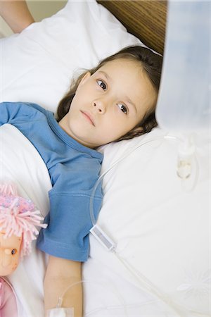 sad single girl pic with bag - Girl lying in hospital bed Stock Photo - Premium Royalty-Free, Code: 695-05765985
