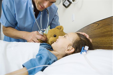 patient on bed and iv - Girl lying in hospital bed, smiling at male nurse Stock Photo - Premium Royalty-Free, Code: 695-05765992