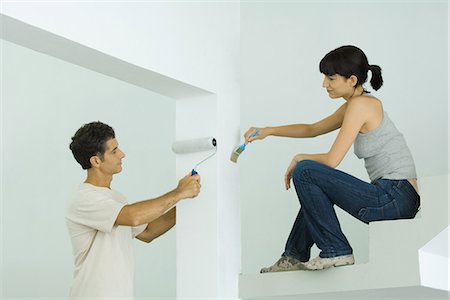 Man and woman painting home interior together Stock Photo - Premium Royalty-Free, Code: 695-05766305