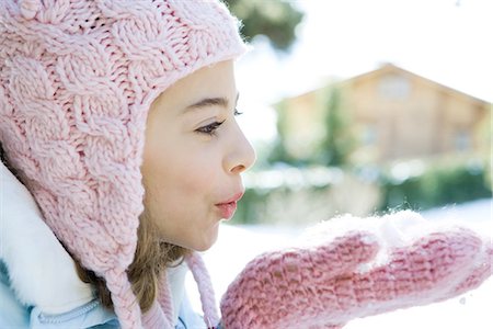 puckered lips profile - Preteen girl blowing handful of snow in mittens, side view Stock Photo - Premium Royalty-Free, Code: 695-05766619