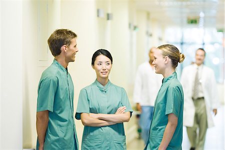 simsearch:695-03389316,k - Three medical workers chatting in hospital corridor Stock Photo - Premium Royalty-Free, Code: 695-05766642